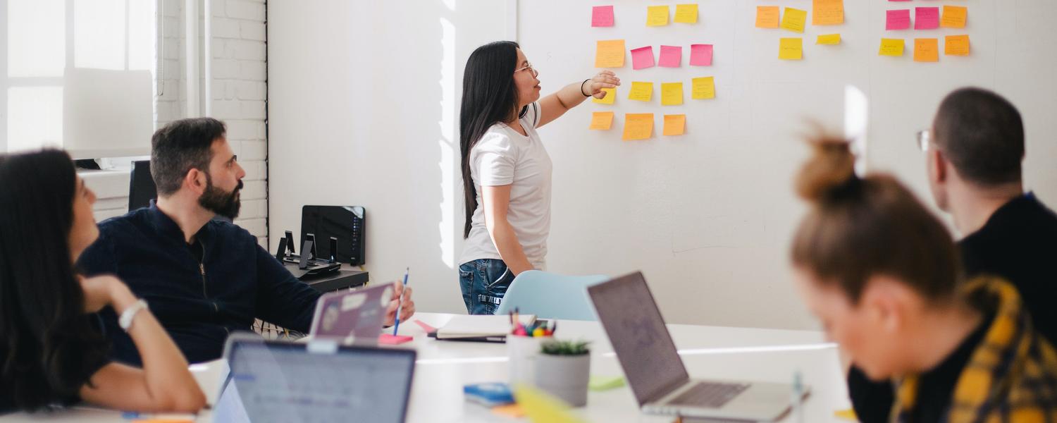 A group of people working in a meeting room.