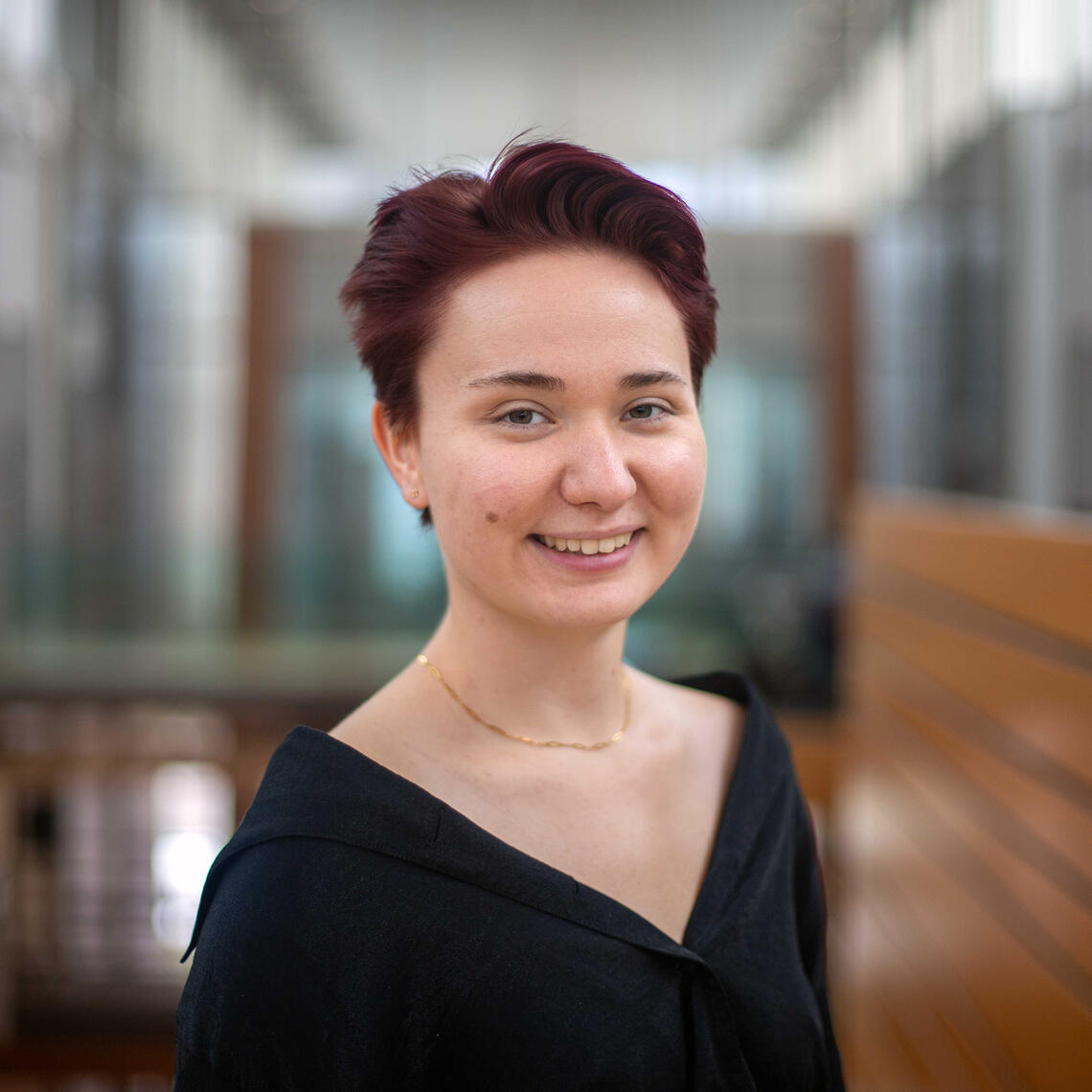 A woman smiles at the camera