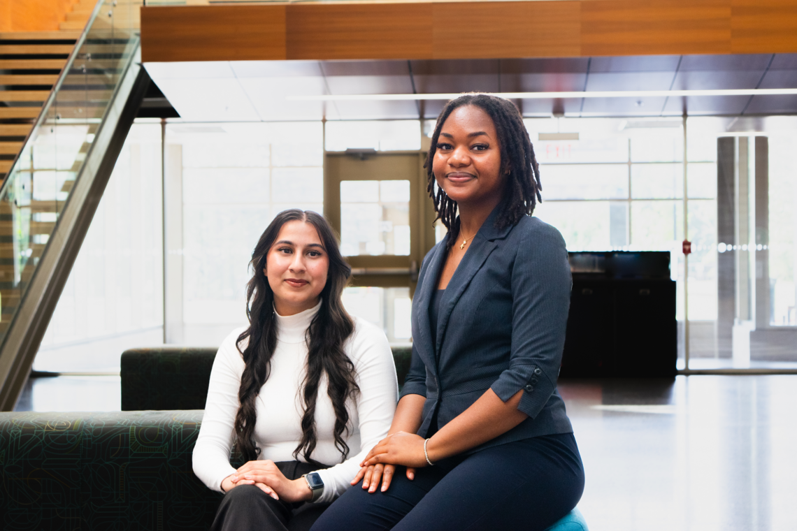 Two NSRA staff members in a seated pose. 