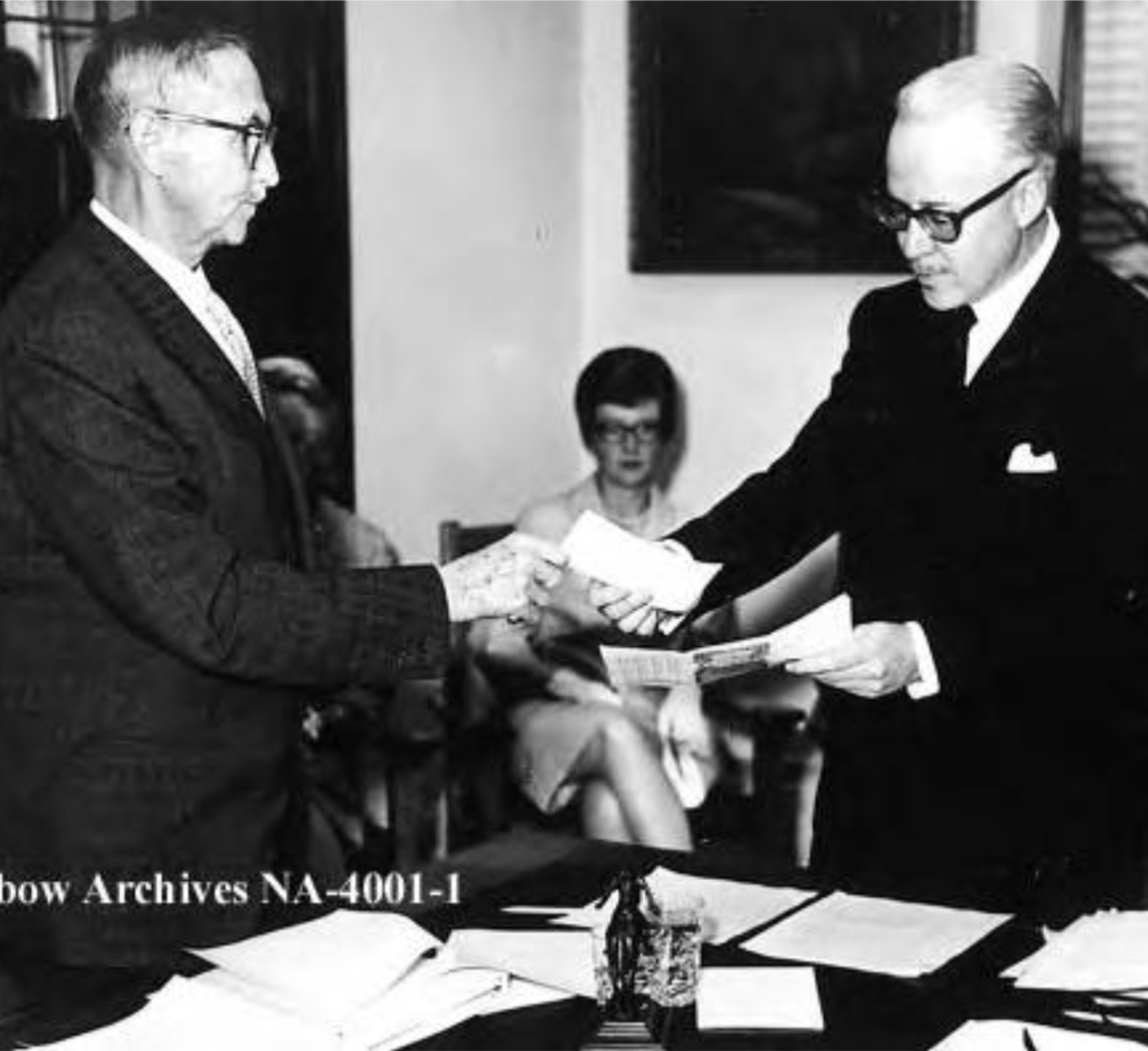 First meeting of new Glenbow Museum organization, took place in old Courthouse on 7th Avenue SW. Eric Harvie, left, handing cheque for $5,000,000 to Honourable Mr. Justice N.D. McDermid, first chairman of the Board of Glenbow governors.