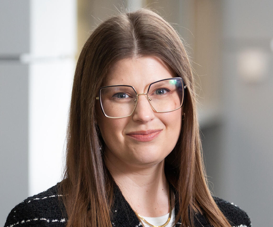 A woman with long hair and glasses