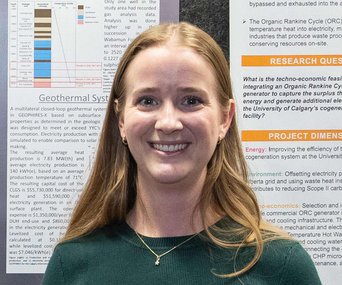 A woman stands in front of a presentation board