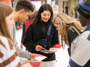 Students conversing while navigating through campus at the You at UCalgary event.