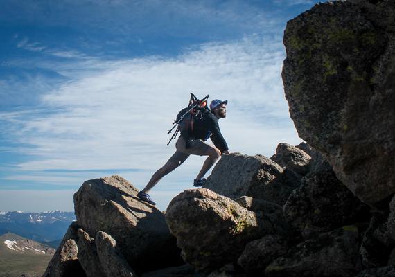 Male person climbing up a mountain