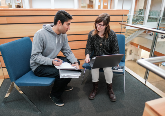 Two students discuss coursework.