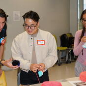 A group of students work on a collaborative art piece