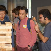 Students work on a Jenga tower