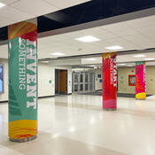 Three large pillars completely wrapped in colourful Start something graphics