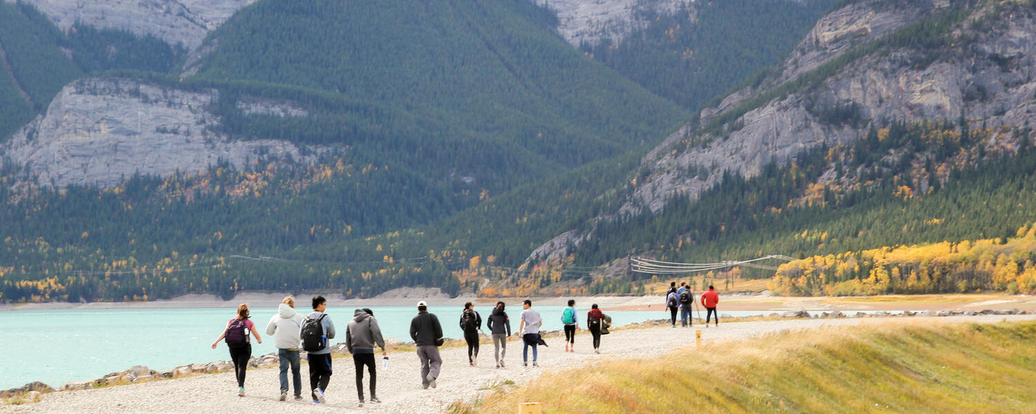 A group of students walking next to Barrier Lake