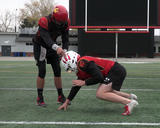 Football athletes performing bobbleheads in a 3-point stance position