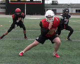 Football athletes performing the lateral lunge portion of the 4-D lunge