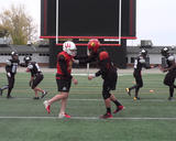 Football athletes performing single-leg partner jousting