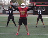 Football players performing jumping jacks