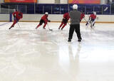 Hockey players reacting to a change of direction cue from their coach on a hockey rink