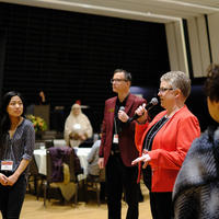 A group speaking with a crowd