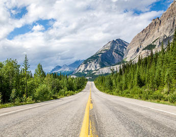 Highway into mountains, sunny day