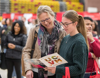 Mother and daughter looking at a viewbook